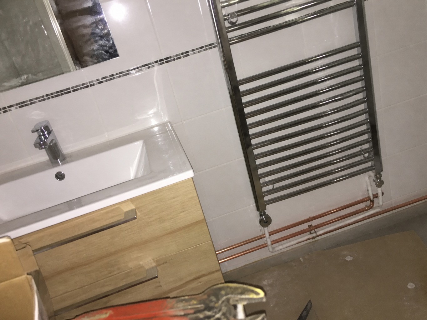 Bathroom plumbing installation before photographic enhancement